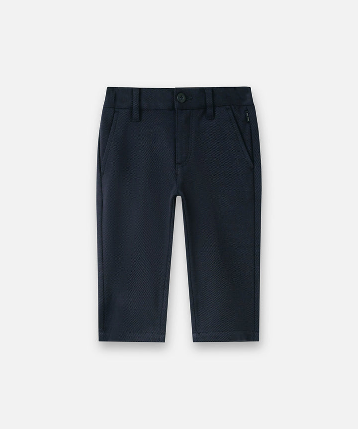 A pair of dark navy blue boys' trousers shown flat against a light gray background.